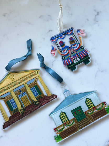 Decorative house ornaments on a marble surface by Elizabeth Sheats