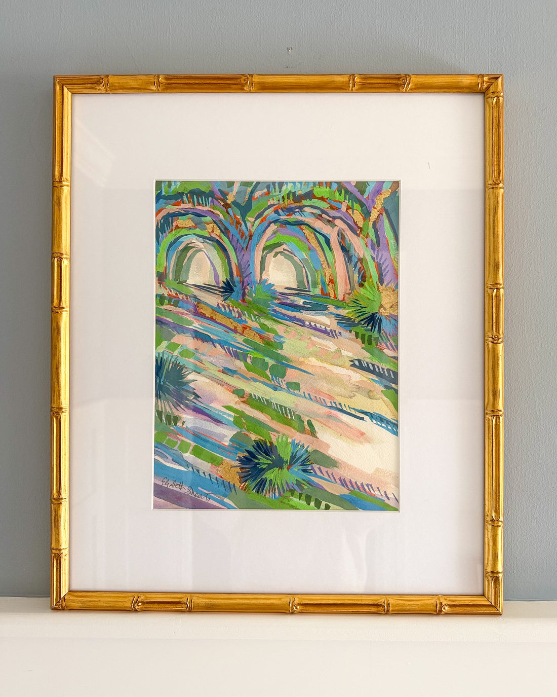 Colorful abstract painting in a gold frame on a gray wall by Elizabeth Sheats
